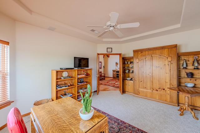 2392 Manzano Loop NE, Rio Rancho, NM 87144 - carpeted living room featuring a tray ceiling, a ceiling fan, and baseboards