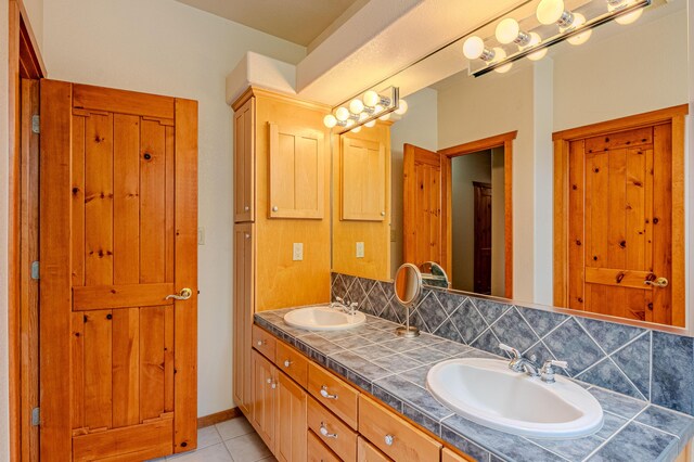 2392 Manzano Loop NE, Rio Rancho, NM 87144 - bathroom with tile patterned floors, backsplash, and double vanity