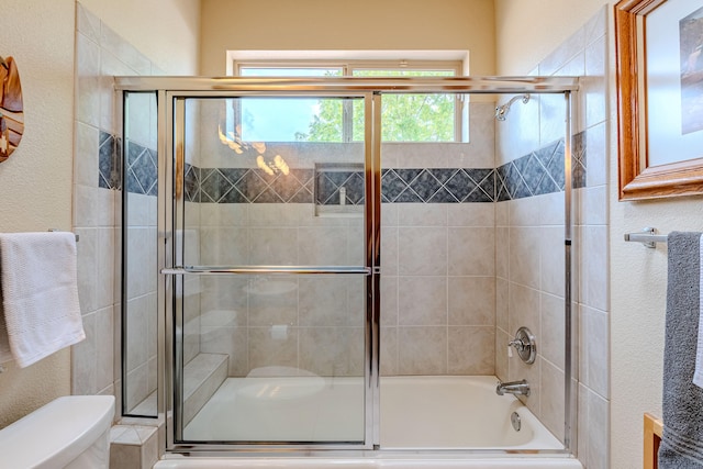 2392 Manzano Loop NE, Rio Rancho, NM 87144 - bathroom featuring toilet, bath / shower combo with glass door, and a textured wall