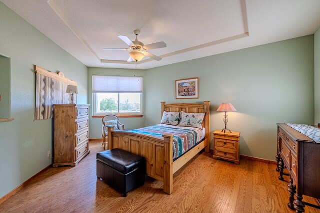 2392 Manzano Loop NE, Rio Rancho, NM 87144 - bedroom with a tray ceiling, light wood-type flooring, baseboards, and ceiling fan