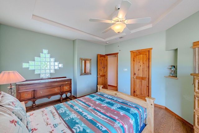 2392 Manzano Loop NE, Rio Rancho, NM 87144 - bedroom featuring a raised ceiling, wood finished floors, ceiling fan, and baseboards