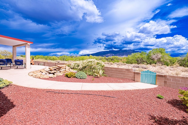 2392 Manzano Loop NE, Rio Rancho, NM 87144 - view of yard with a patio, a mountain view, and fence