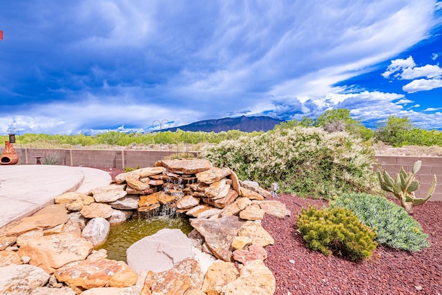 2392 Manzano Loop NE, Rio Rancho, NM 87144 - view of yard with a garden pond, fence, and a mountain view