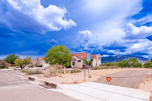 2392 Manzano Loop NE, Rio Rancho, NM 87144 - mediterranean / spanish home featuring stucco siding, a mountain view, and a tiled roof