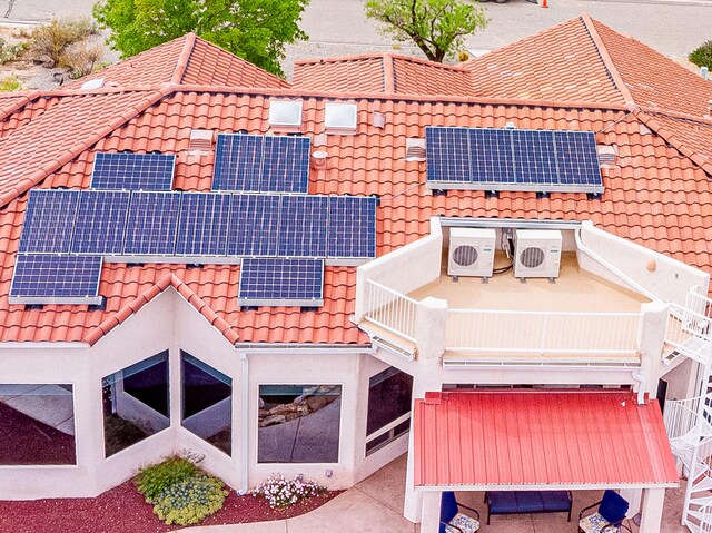 2392 Manzano Loop NE, Rio Rancho, NM 87144 - rear view of property featuring a tiled roof, roof mounted solar panels, and ac unit
