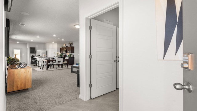 2734 Cantara Ln, Albuquerque, NM 87121 - hall featuring light carpet, light tile patterned floors, recessed lighting, and a textured ceiling