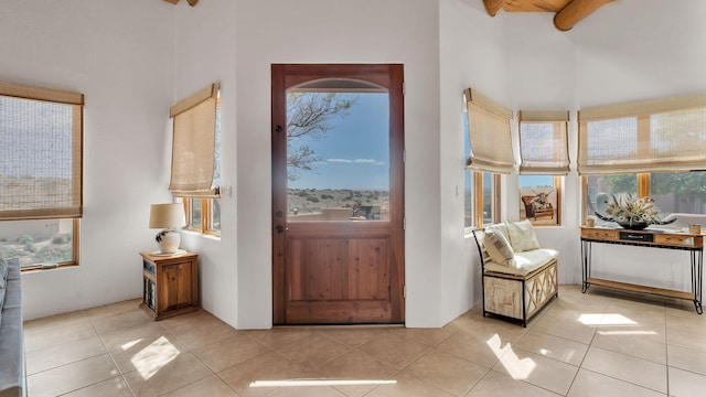 59 Sky Mountain Rd, Placitas, NM 87043 - entryway featuring a towering ceiling, healthy amount of natural light, and light tile patterned floors