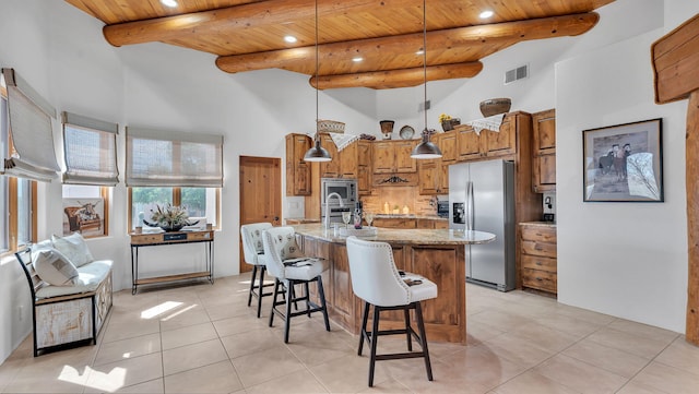 59 Sky Mountain Rd, Placitas, NM 87043 - kitchen with stainless steel appliances, wood ceiling, a towering ceiling, brown cabinetry, and recessed lighting