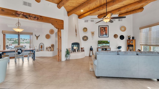 59 Sky Mountain Rd, Placitas, NM 87043 - living area featuring wooden ceiling, beamed ceiling, light tile patterned floors, plenty of natural light, and ceiling fan