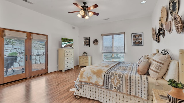 59 Sky Mountain Rd, Placitas, NM 87043 - bedroom with access to exterior, multiple windows, wood finished floors, french doors, and recessed lighting