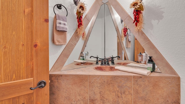 59 Sky Mountain Rd, Placitas, NM 87043 - bathroom with a textured wall and vanity