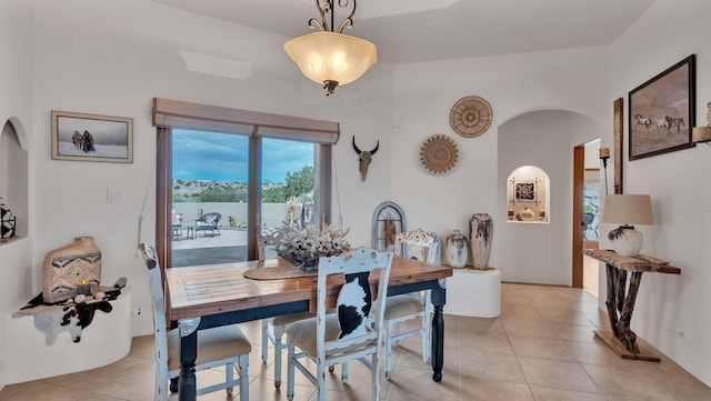 59 Sky Mountain Rd, Placitas, NM 87043 - dining room with arched walkways and light tile patterned floors
