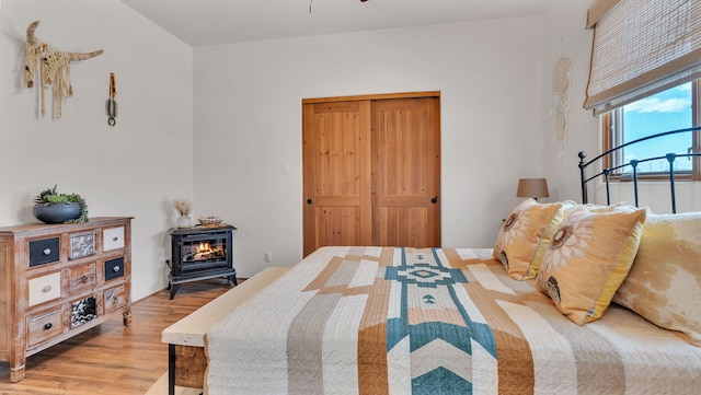 59 Sky Mountain Rd, Placitas, NM 87043 - bedroom with light wood-style floors and a wood stove