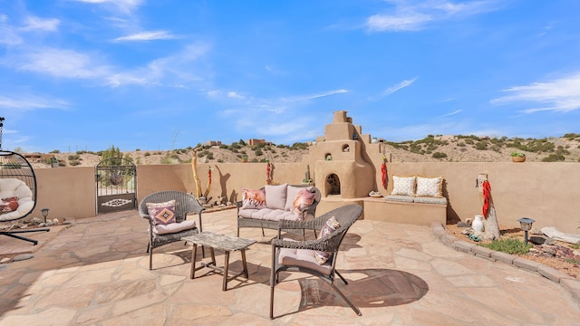 59 Sky Mountain Rd, Placitas, NM 87043 - view of patio featuring an outdoor living space with a fireplace, fence, and a gate