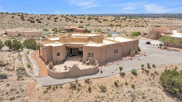 59 Sky Mountain Rd, Placitas, NM 87043 - back of property with a desert view, stucco siding, and a view of countryside