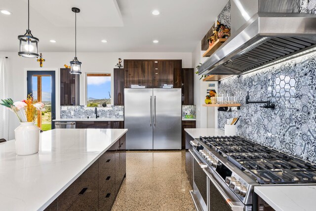 3 Bartram Ct, Sandia Park, NM 87047 - kitchen with premium appliances, wall chimney range hood, recessed lighting, dark brown cabinets, and dark speckled floor