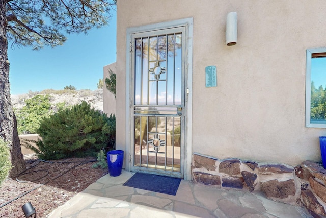 52 Tejon Canon Rd, Placitas, NM 87043 - property entrance featuring stucco siding