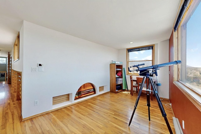 52 Tejon Canon Rd, Placitas, NM 87043 - exercise area featuring light wood-type flooring, plenty of natural light, and baseboard heating