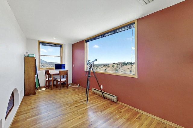 52 Tejon Canon Rd, Placitas, NM 87043 - office with baseboard heating, wood finished floors, and baseboards