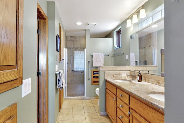 52 Tejon Canon Rd, Placitas, NM 87043 - bathroom featuring a stall shower, double vanity, toilet, tile patterned flooring, and decorative backsplash
