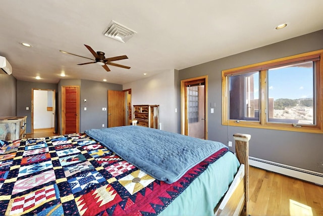 52 Tejon Canon Rd, Placitas, NM 87043 - bedroom with a baseboard heating unit, wood finished floors, recessed lighting, and a ceiling fan