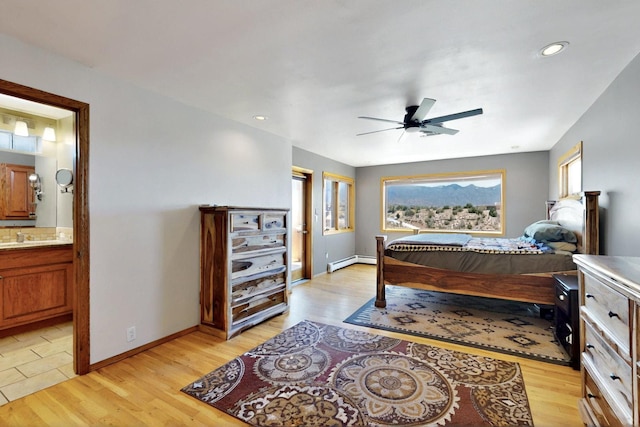 52 Tejon Canon Rd, Placitas, NM 87043 - bedroom featuring a baseboard heating unit, light wood finished floors, baseboards, ensuite bath, and recessed lighting