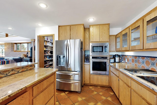 52 Tejon Canon Rd, Placitas, NM 87043 - kitchen featuring appliances with stainless steel finishes, decorative backsplash, glass insert cabinets, light stone countertops, and recessed lighting