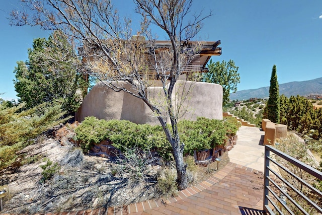 52 Tejon Canon Rd, Placitas, NM 87043 - view of property exterior featuring stucco siding, a mountain view, and stairs