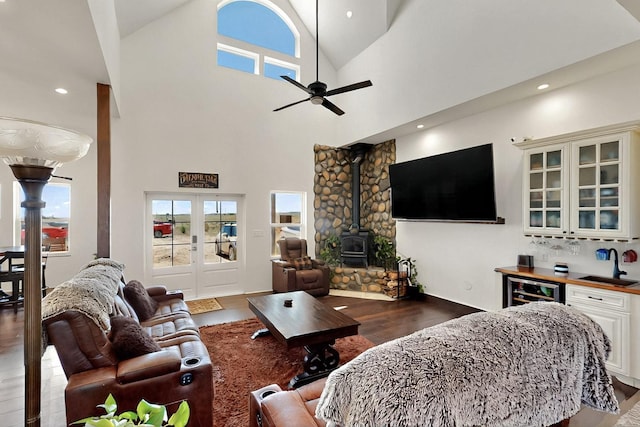 420 Bassett Blvd, Edgewood, NM 87015 - living room with ceiling fan, wood finished floors, bar, a wood stove, and wine cooler