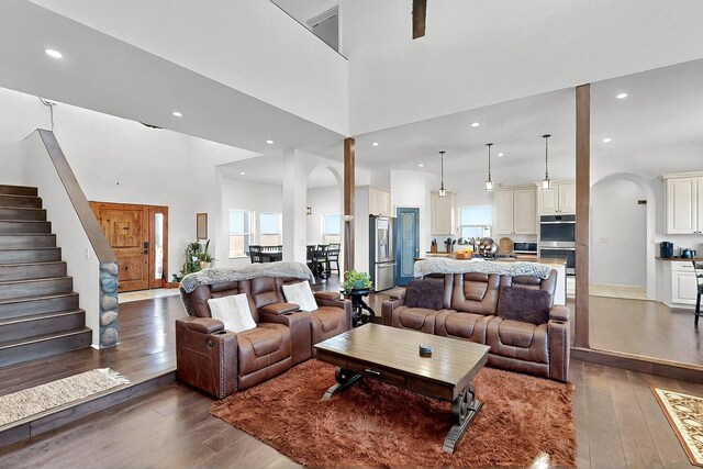 420 Bassett Blvd, Edgewood, NM 87015 - living area with wood-type flooring, arched walkways, recessed lighting, a high ceiling, and stairway