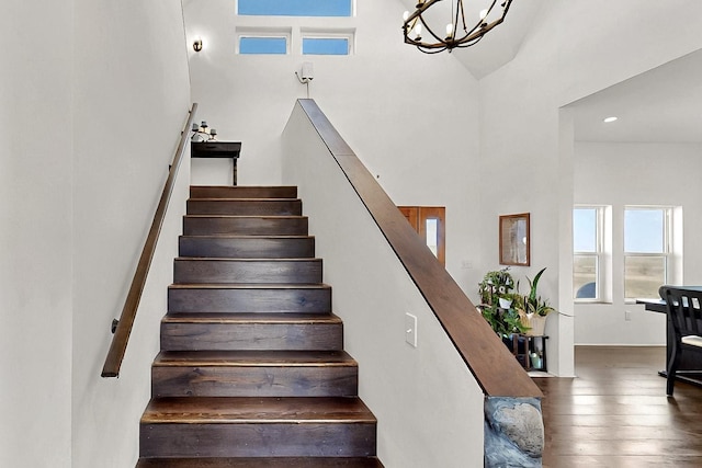 420 Bassett Blvd, Edgewood, NM 87015 - staircase featuring a high ceiling, a chandelier, and wood-type flooring