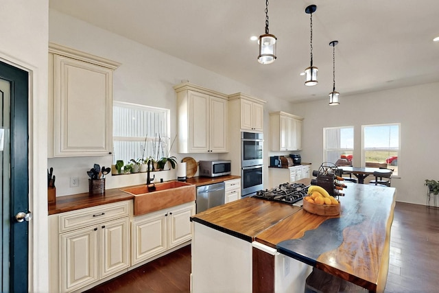420 Bassett Blvd, Edgewood, NM 87015 - kitchen with cream cabinets, wood counters, appliances with stainless steel finishes, and a sink