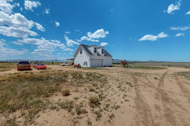 420 Bassett Blvd, Edgewood, NM 87015 - view of yard with a playground, a detached garage, driveway, a view of countryside, and a mountain view