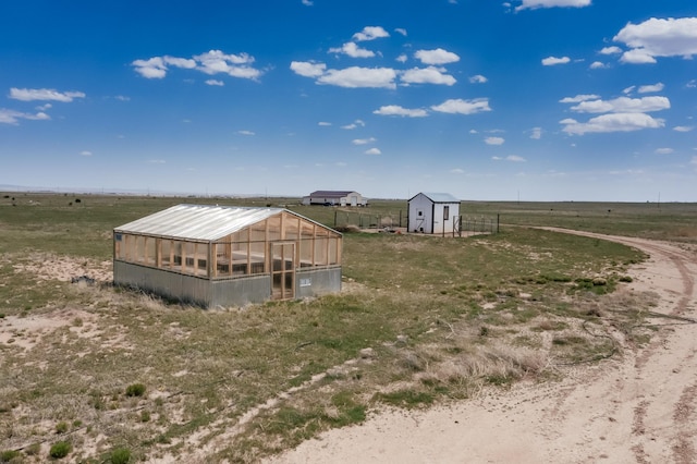 420 Bassett Blvd, Edgewood, NM 87015 - view of yard with a greenhouse, an outbuilding, and a view of rural / pastoral area