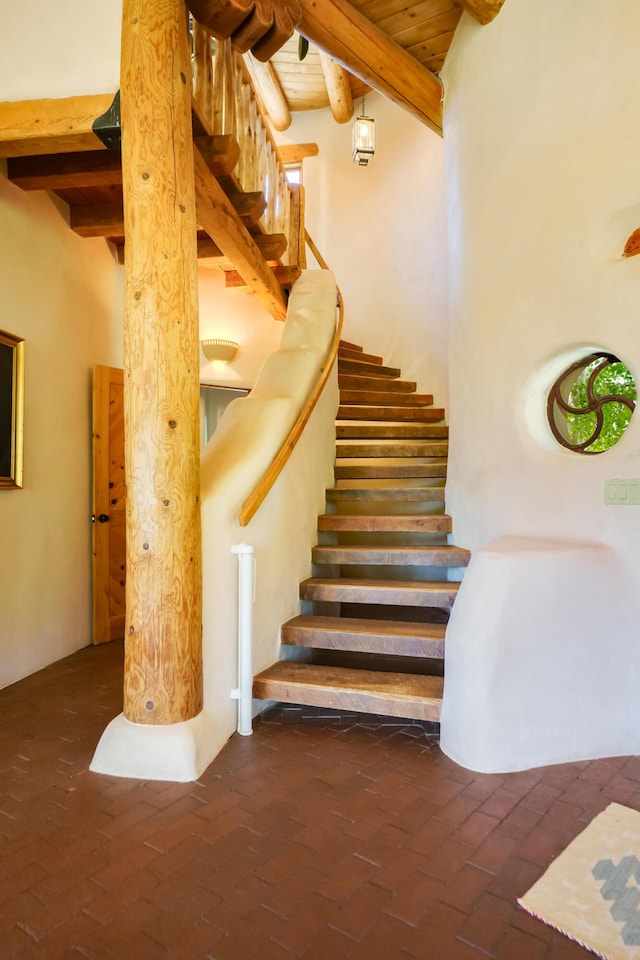 59 Perdiz Canyon Rd, Placitas, NM 87043 - stairs featuring brick floors and wooden ceiling with exposed beams