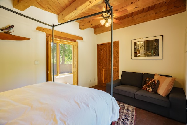 59 Perdiz Canyon Rd, Placitas, NM 87043 - bedroom featuring wood ceiling with exposed beams, brick flooring, and a ceiling fan