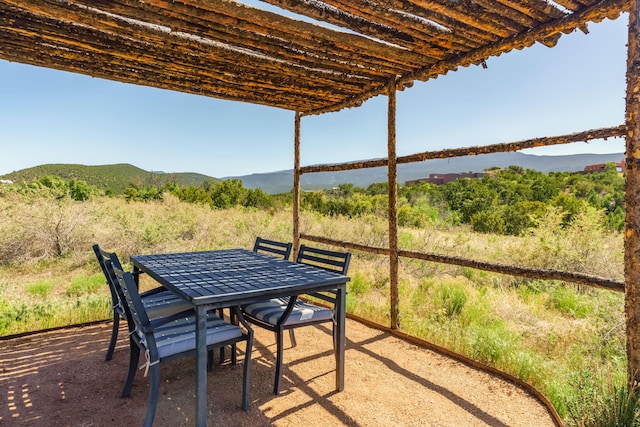 59 Perdiz Canyon Rd, Placitas, NM 87043 - view of patio with outdoor dining space and a mountain view