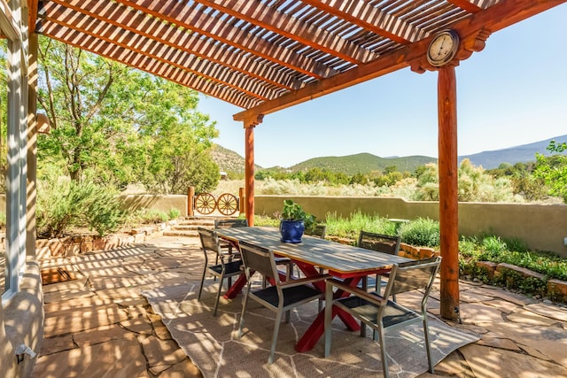 59 Perdiz Canyon Rd, Placitas, NM 87043 - view of patio / terrace featuring a mountain view, outdoor dining space, and a pergola