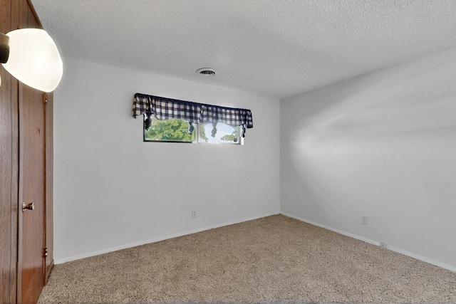 1614 Del Monte Trl SW, Albuquerque, NM 87121 - spare room featuring carpet flooring, a textured ceiling, and baseboards