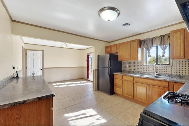 1614 Del Monte Trl SW, Albuquerque, NM 87121 - kitchen featuring a sink, freestanding refrigerator, decorative backsplash, crown molding, and light tile patterned floors
