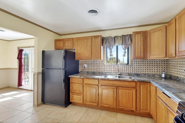 1614 Del Monte Trl SW, Albuquerque, NM 87121 - kitchen featuring freestanding refrigerator, light tile patterned floors, ornamental molding, tasteful backsplash, and plenty of natural light