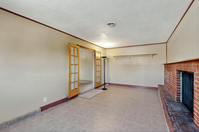 1614 Del Monte Trl SW, Albuquerque, NM 87121 - unfurnished living room featuring a fireplace, crown molding, a textured ceiling, light tile patterned floors, and french doors