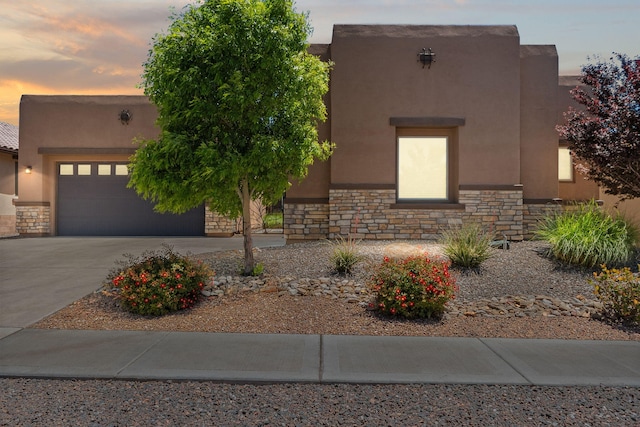 6808 Vista Luces St NW, Albuquerque, NM 87120 - southwest-style home featuring stone siding, driveway, stucco siding, and an attached garage