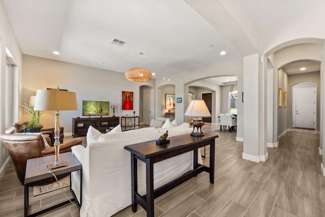 6808 Vista Luces St NW, Albuquerque, NM 87120 - living area featuring baseboards, arched walkways, recessed lighting, and light wood-type flooring