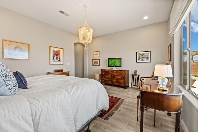 6808 Vista Luces St NW, Albuquerque, NM 87120 - bedroom with arched walkways, wood finish floors, recessed lighting, and baseboards