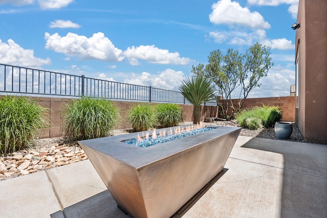 6808 Vista Luces St NW, Albuquerque, NM 87120 - view of patio / terrace featuring an outdoor fire pit and a fenced backyard