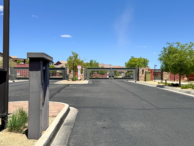 729 Sierra Verde Way NE, Rio Rancho, NM 87124 - view of asphalt road with a gate, curbs, and a gated entry