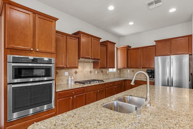 729 Sierra Verde Way NE, Rio Rancho, NM 87124 - kitchen with appliances with stainless steel finishes, a sink, tasteful backsplash, recessed lighting, and light stone counters
