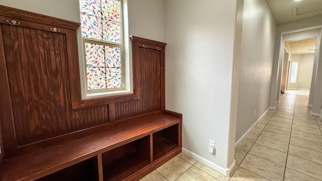 729 Sierra Verde Way NE, Rio Rancho, NM 87124 - mudroom featuring light tile patterned floors, baseboards, attic access, and a textured wall