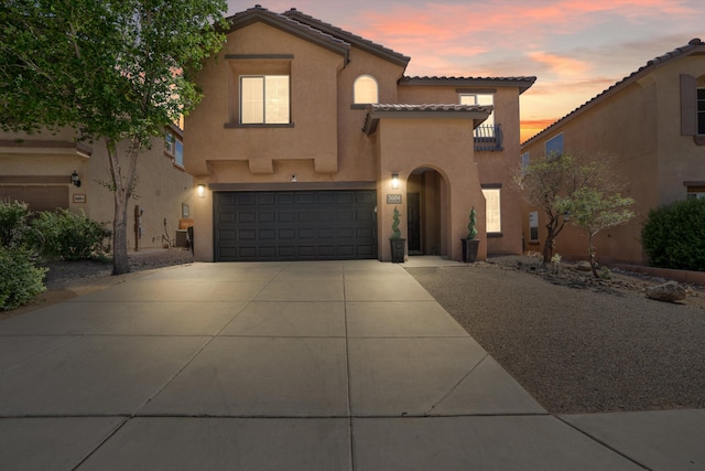 3604 Plano Vista Rd NE, Rio Rancho, NM 87124 - mediterranean / spanish house with stucco siding, driveway, an attached garage, a tiled roof, and a balcony